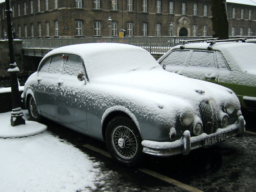 On my way to work, I saw a beautiful car, a Jaguar Mk2, covered with snow.